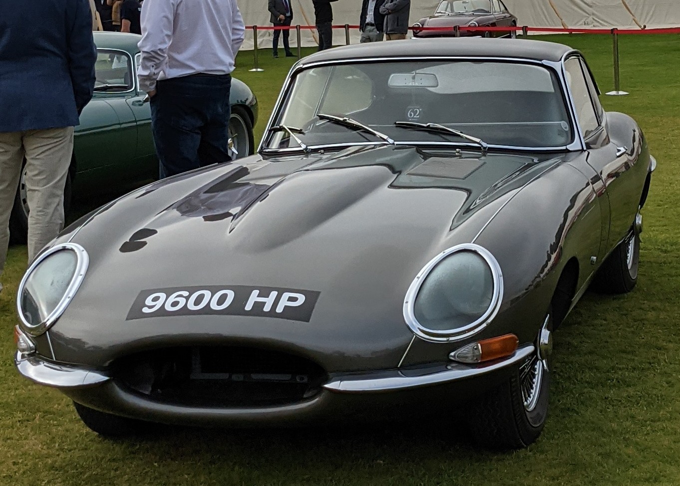 Grey Jaguar E-Type fixed-head coupé with the registration 9600 HP on a show lawn