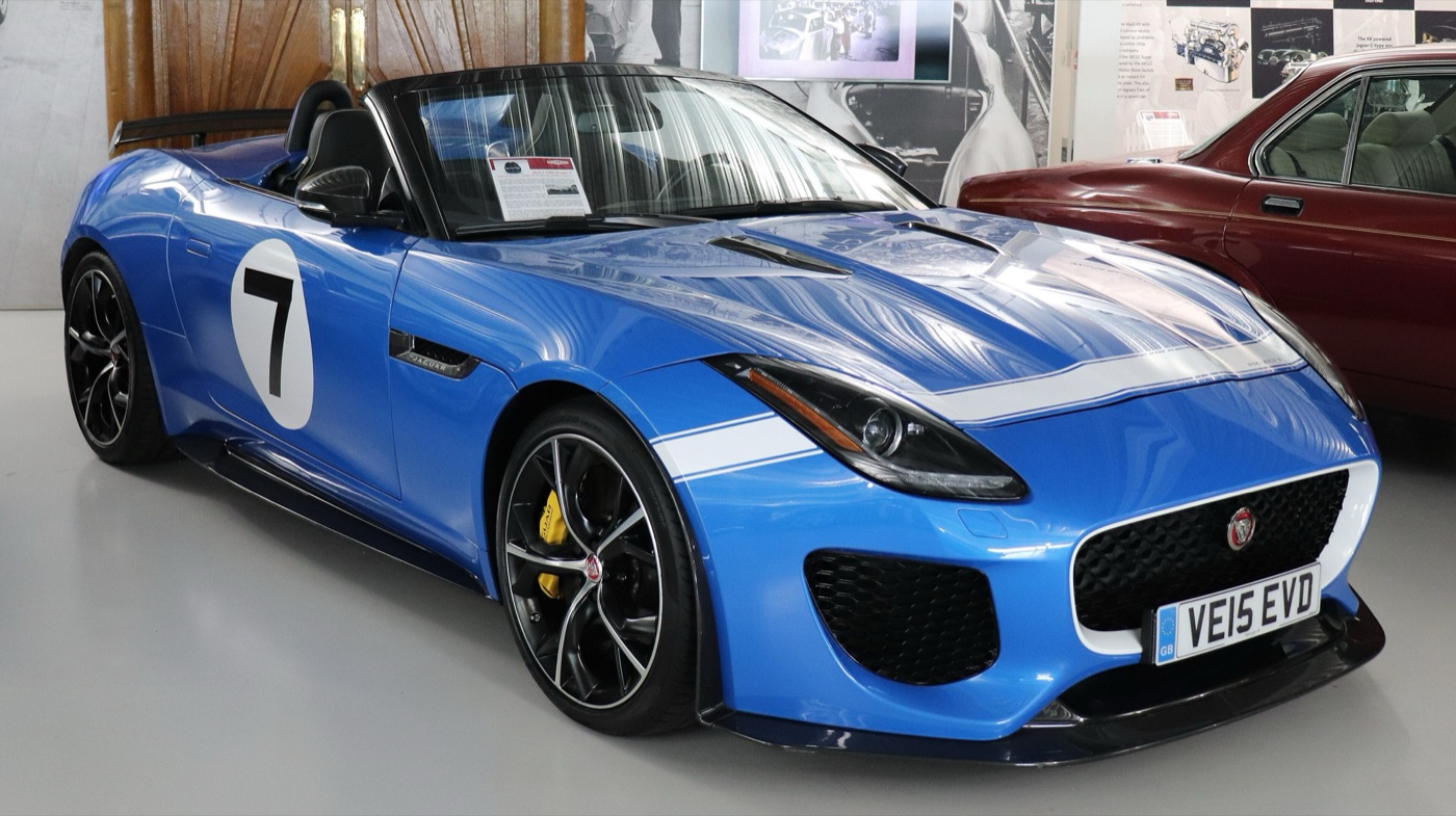 Blue Jaguar F-Type Project 7 roadster with white stripes, a number 7 roundel and a fairing behind the driver
