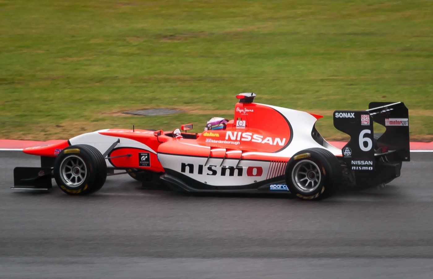 Red and white Arden GP3 car number 6 with Nissan and Nismo logos on a wet track