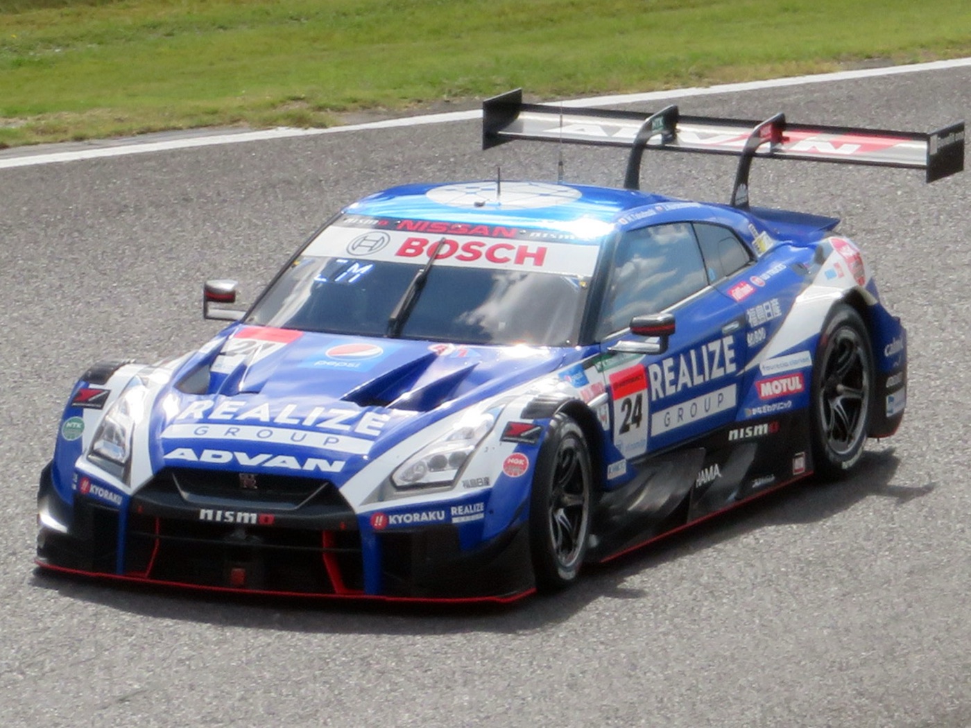 Blue and white Realize Advan Nissan GT-R GT500 car number 24 on track at Suzuka