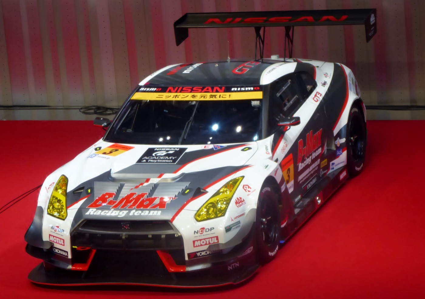 White, grey and red B-Max NDDP Nissan GT-R GT3 number 3 on display with a GT Academy logo on its bonnet