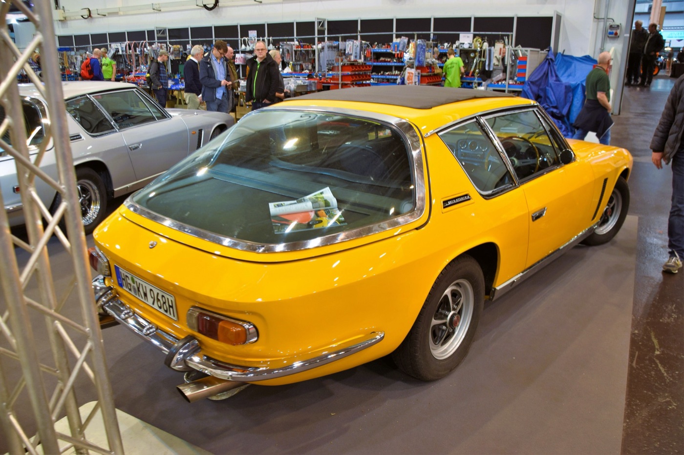 Yellow 1968 Jensen Interceptor Mark I seen from the rear three-quarter, showing the large curved glass tailgate