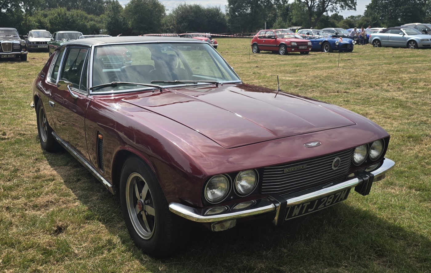 Maroon Jensen Interceptor Mark III with five-spoke alloy wheels at an outdoor car show