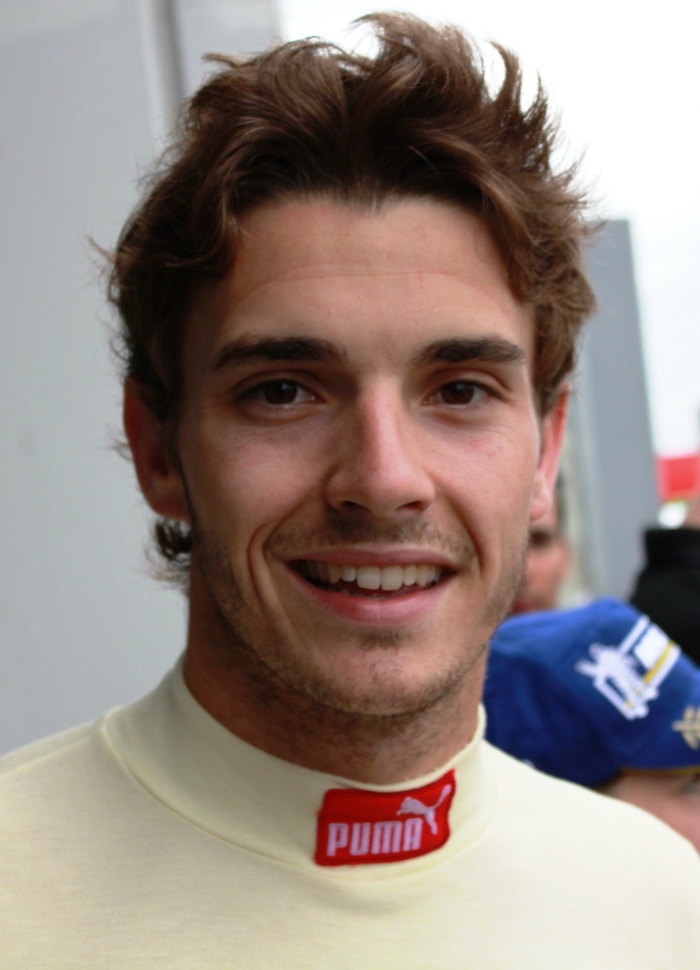 Close portrait of a smiling Jules Bianchi in a cream race undershirt