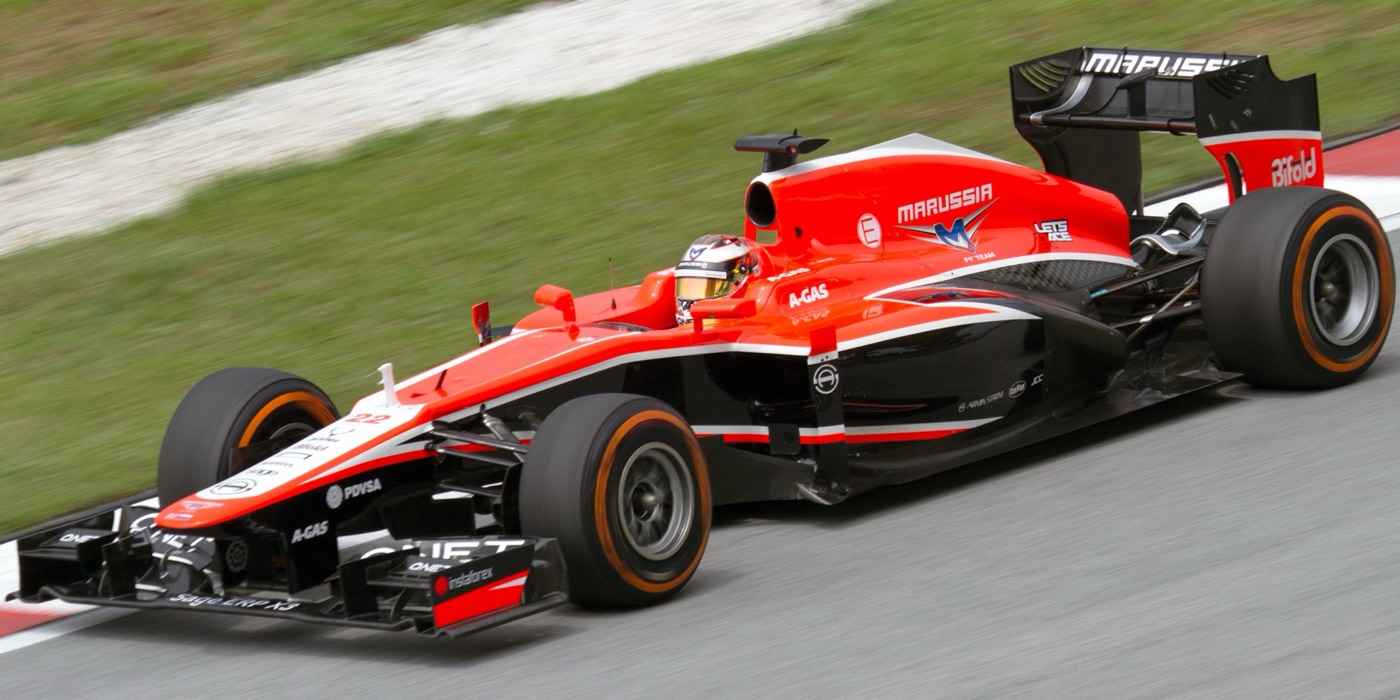 Red and black Marussia MR02 Formula One car on track at Sepang