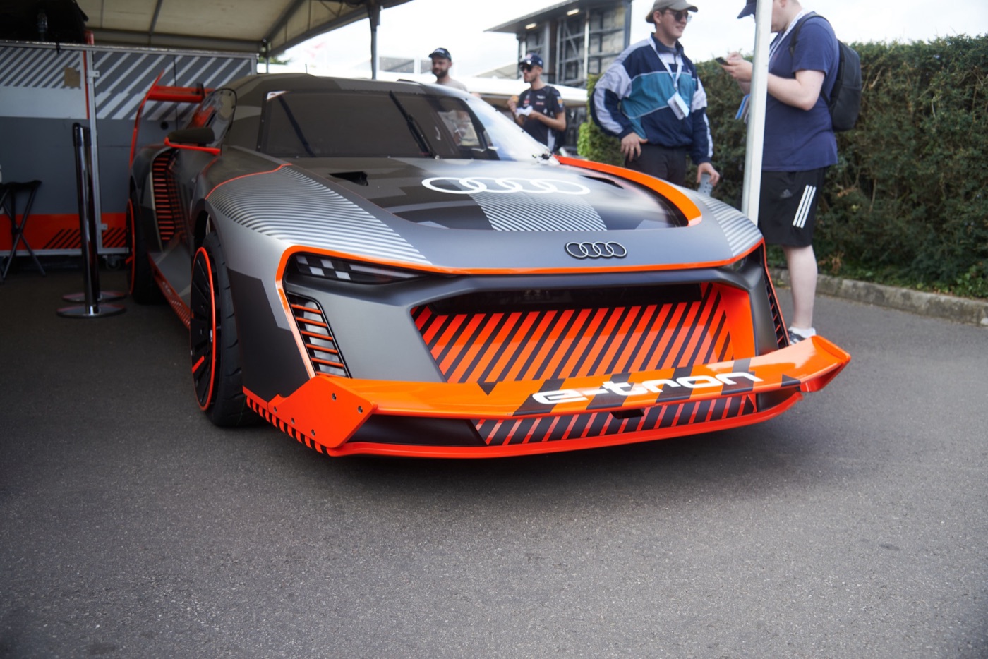 Grey and orange Audi S1 Hoonitron electric car parked under an awning