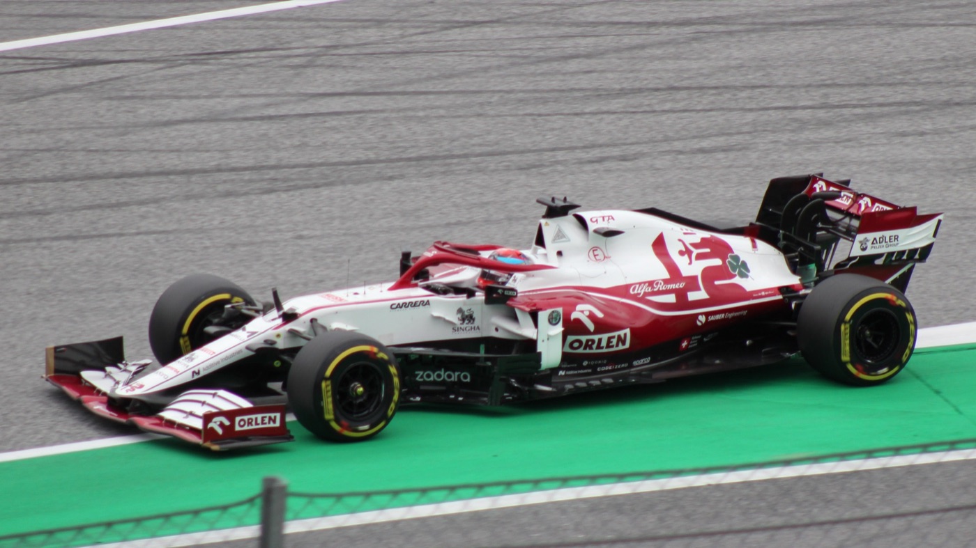 White and red Alfa Romeo C41 with Orlen sponsorship on track beside a green run-off area