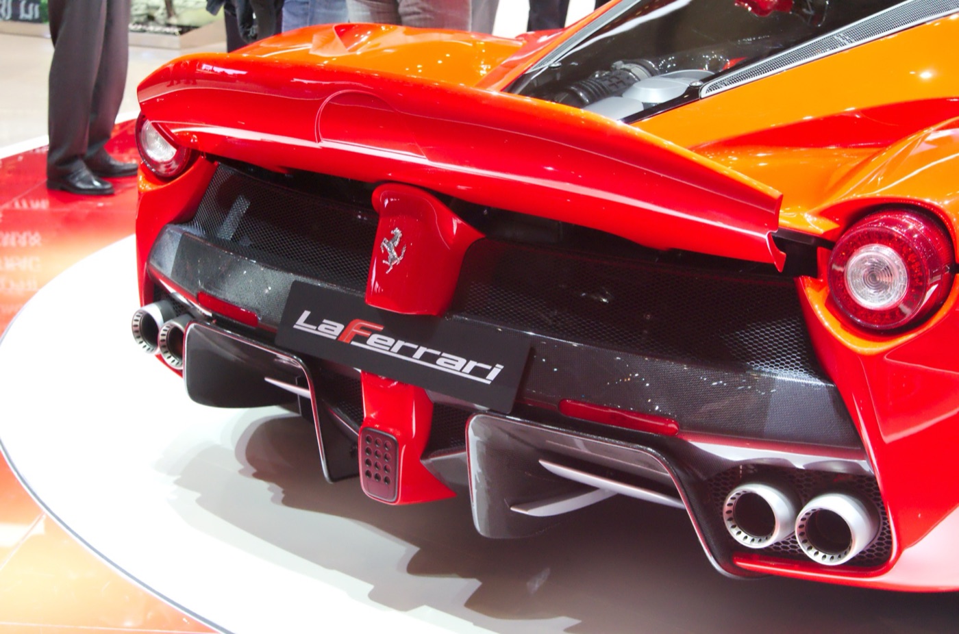 Rear of a red LaFerrari showing the LaFerrari badge, carbon diffuser, twin exhaust pairs and the spoiler above