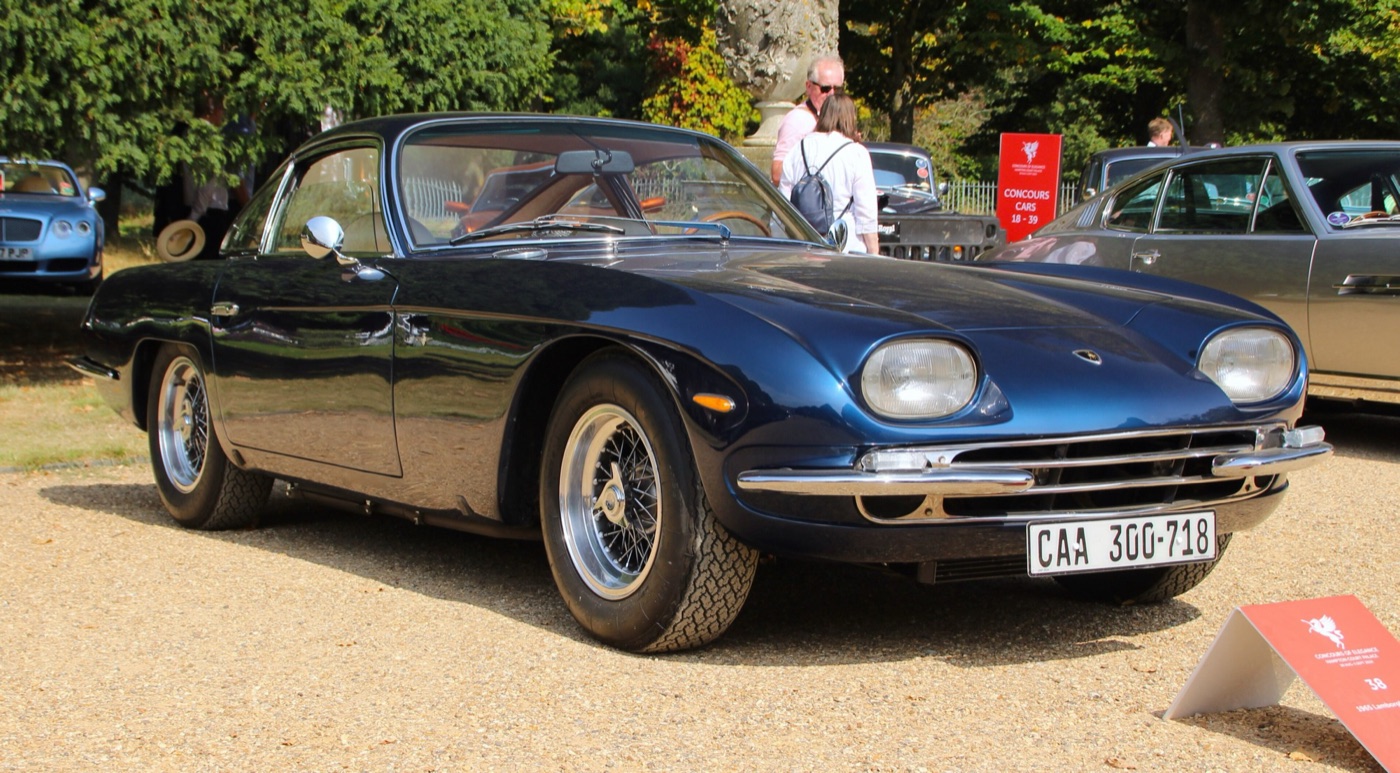 Navy blue 1965 Lamborghini 350 GT, the company’s first production car, parked on gravel at the Hampton Court Concours