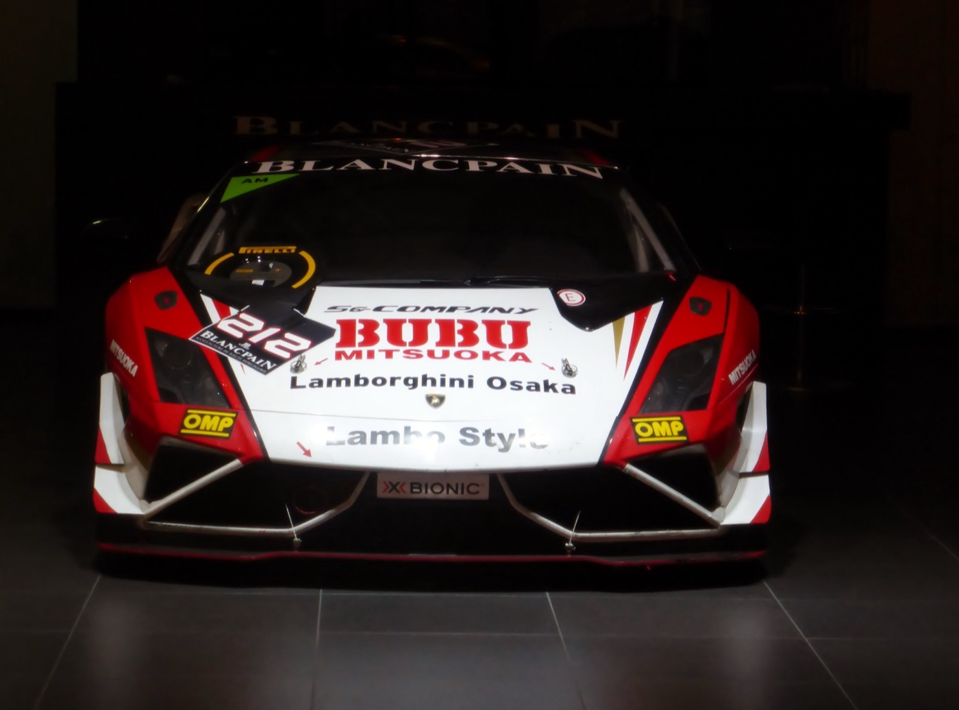 Front view of a red and white Gallardo Super Trofeo race car, number 212, with Blancpain and Lamborghini Osaka decals