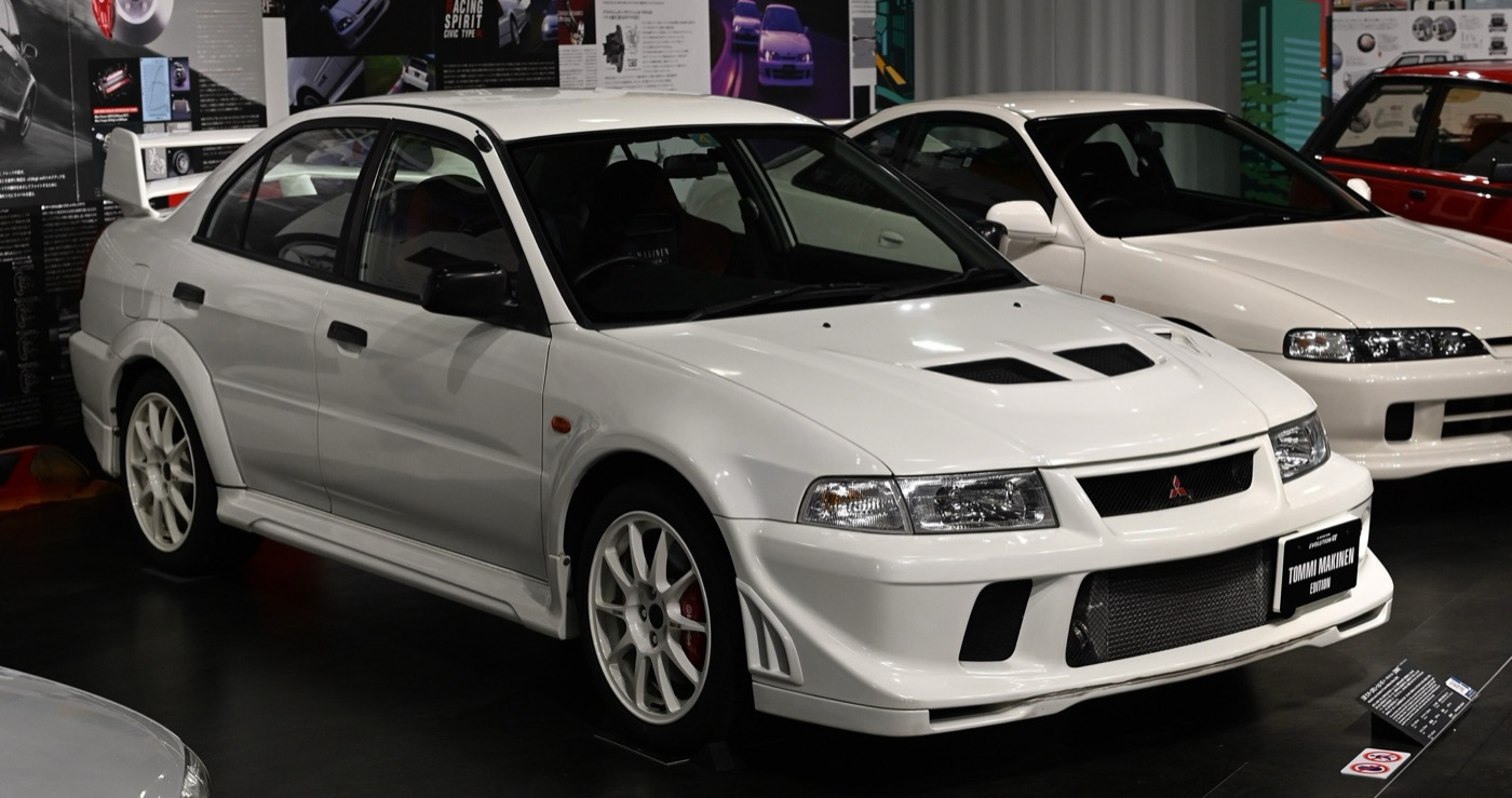 White Mitsubishi Lancer RS Evolution VI Tommi Makinen Edition on display, front three-quarter view