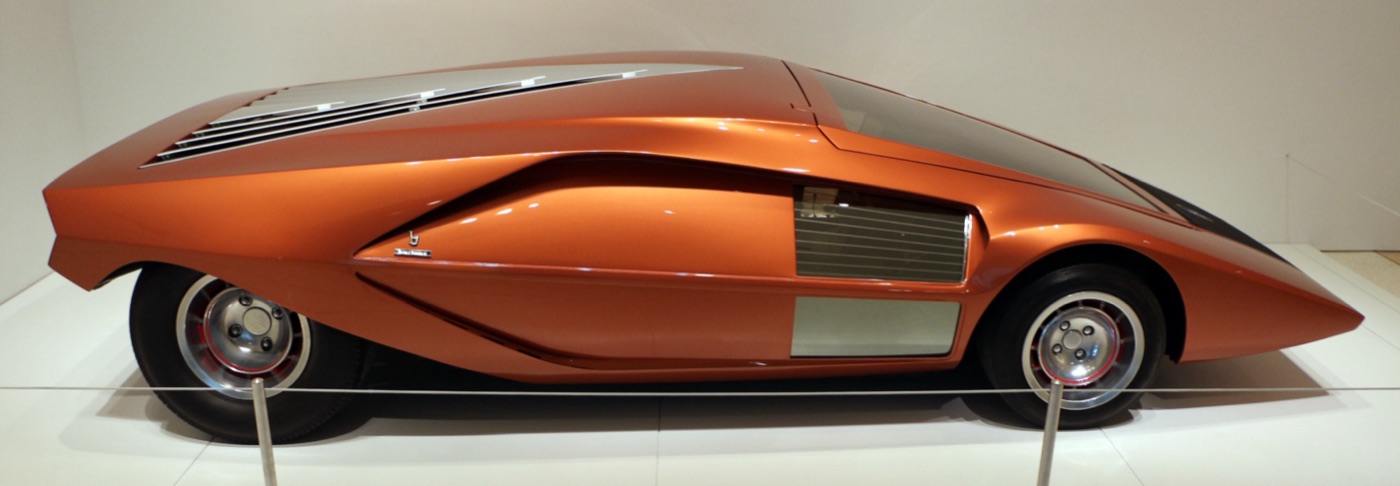 Side view of the orange 1970 Lancia Stratos Zero show car, a low wedge with louvres across its tail