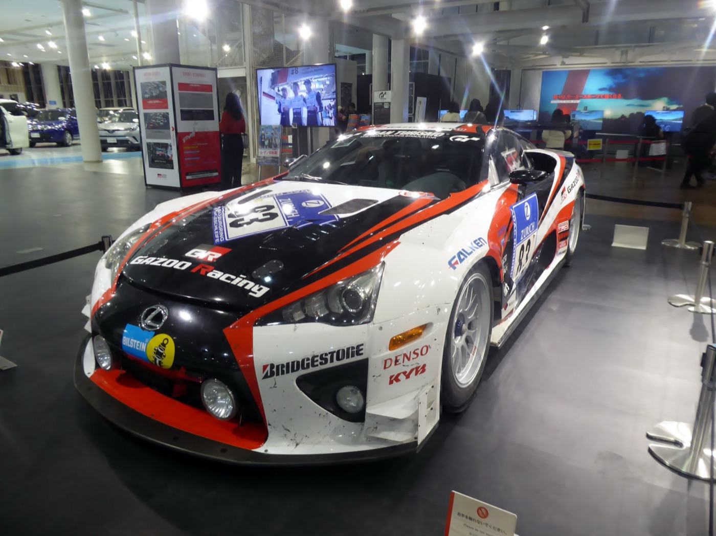 White, black and red Gazoo Racing Lexus LFA race car number 83 on display indoors