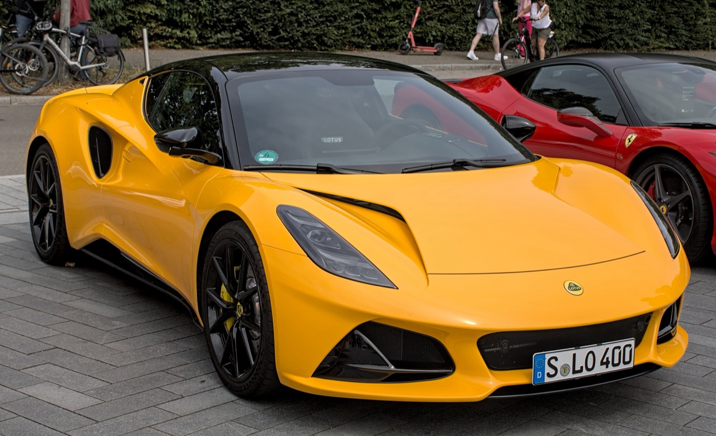 Yellow Lotus Emira sports coupé with a black roof parked on paving in Stuttgart