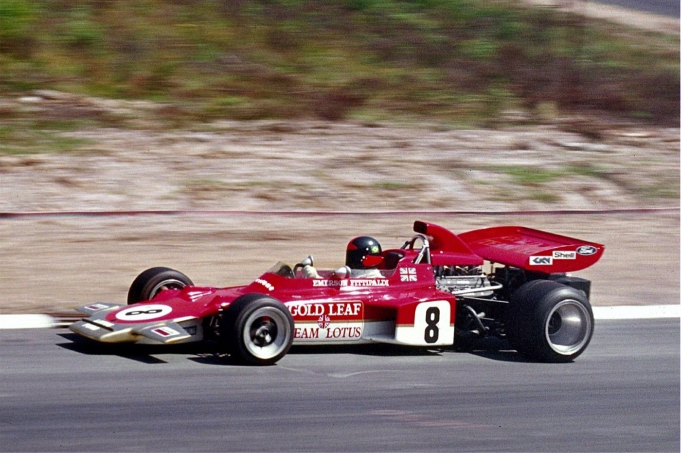 Red, white and gold Gold Leaf Team Lotus 72 single-seater number 8 driven by Emerson Fittipaldi on a track