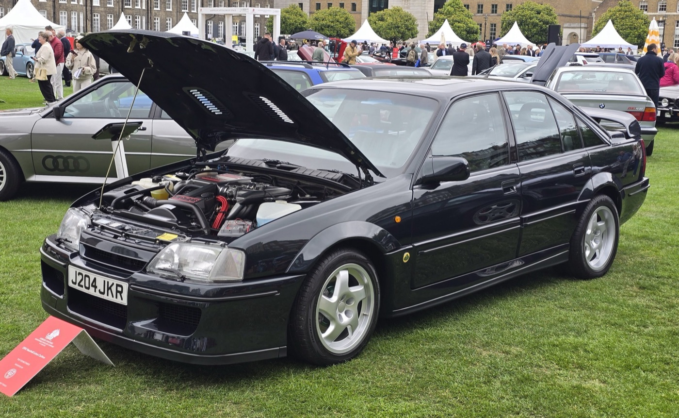 Dark green-black 1991 Lotus Carlton saloon with its bonnet raised at the London Concours