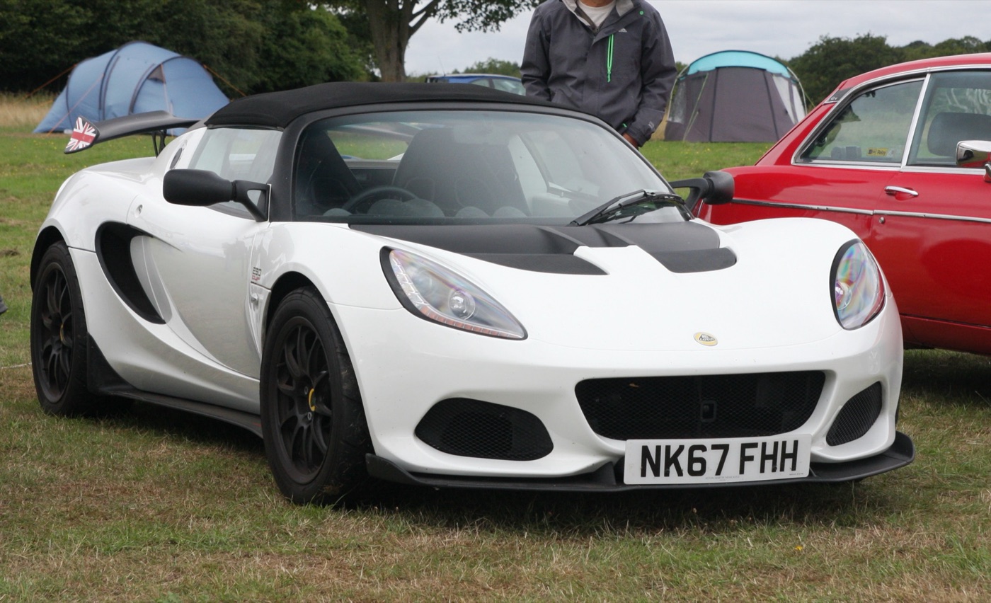 White Lotus Elise Series 3 with black roof, black bonnet vents and black wheels parked on grass at a car show
