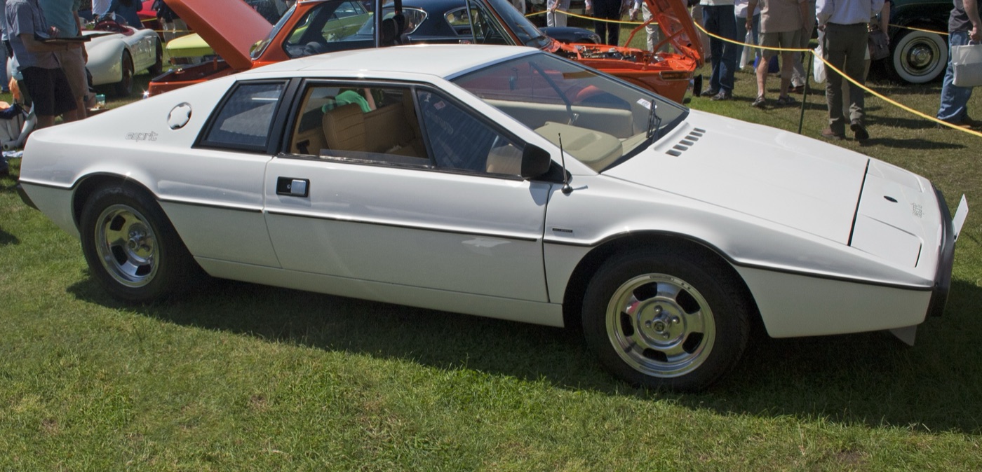 White early Lotus Esprit S1 with Wolfrace alloy wheels, seen side-on on grass at a concours