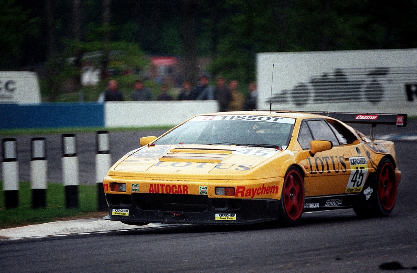 Yellow Lotus Esprit Sport 300 race car number 45 with a large rear wing cornering at Donington