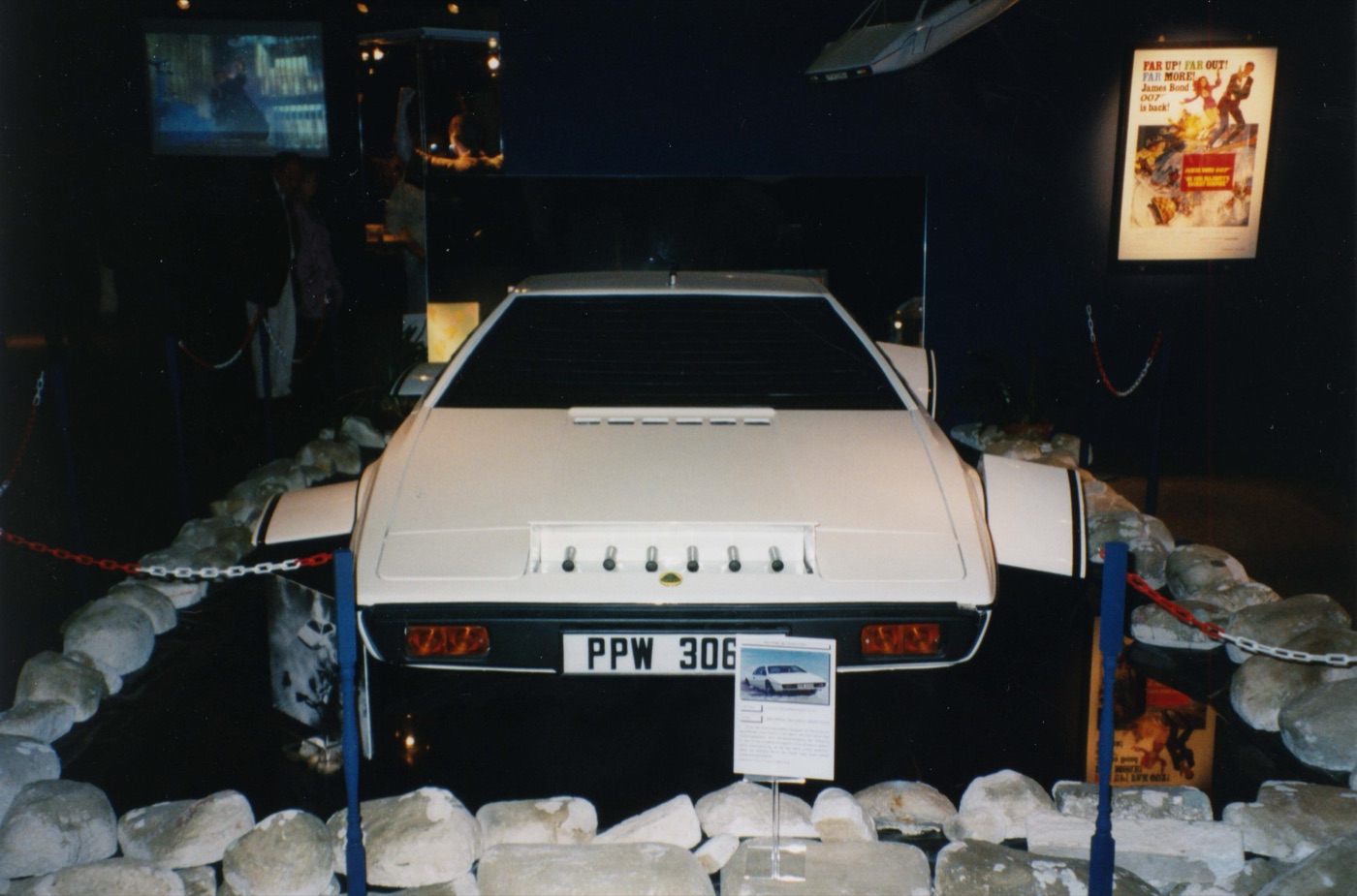 White Lotus Esprit submarine prop with fins in the wheel arches, displayed on rocks at an exhibition