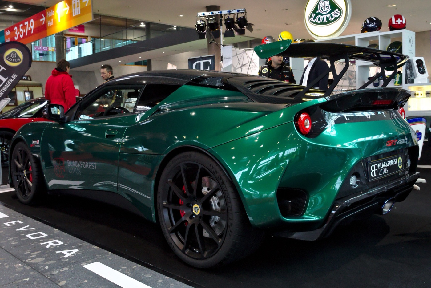 Green Lotus Evora GT430 with a large carbon rear wing, seen from the rear three-quarter