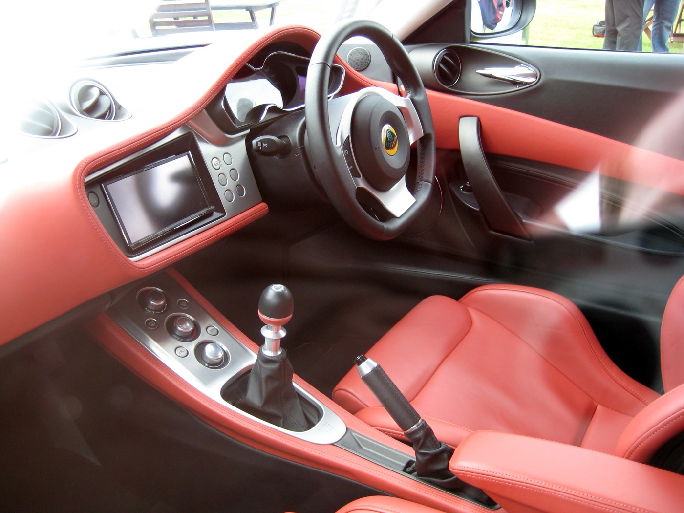Right-hand-drive Lotus Evora interior with red leather seats, door trims and dashboard