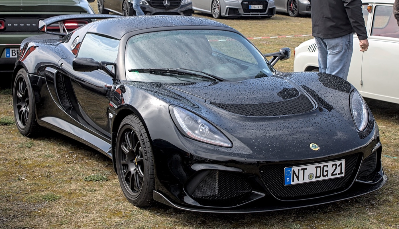 Black Lotus Exige Sport 390 Final Edition wet with rain, seen from the front three-quarter