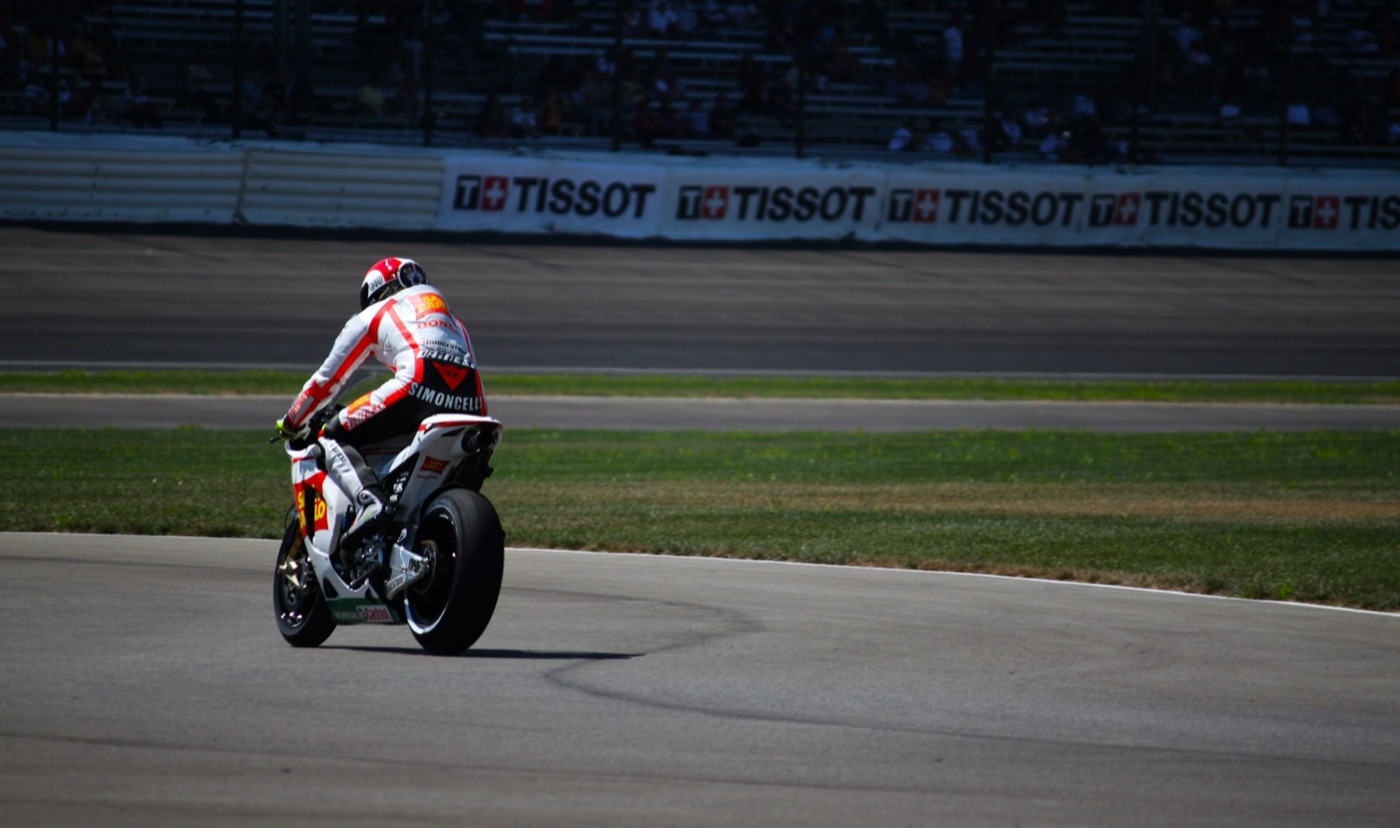 Marco Simoncelli on the San Carlo Gresini Honda, seen from behind, on the infield at Indianapolis