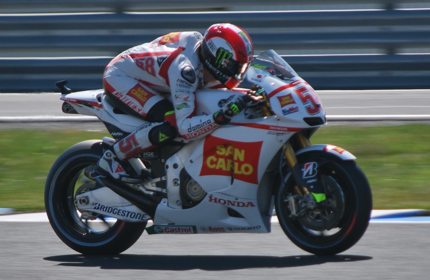 Marco Simoncelli leaning the white San Carlo Gresini Honda number 58 through a corner at Phillip Island