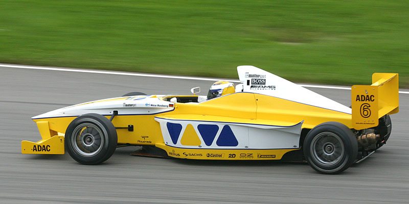 Yellow and white Formula BMW single-seater with ADAC number 6 on the rear wing, Nico Rosberg’s name on the cockpit side, at speed