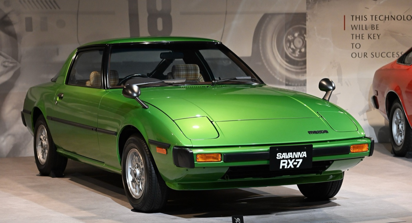 Green 1978 Mazda Savanna RX-7 coupé with pop-up headlamps closed, on display at the Mazda Museum