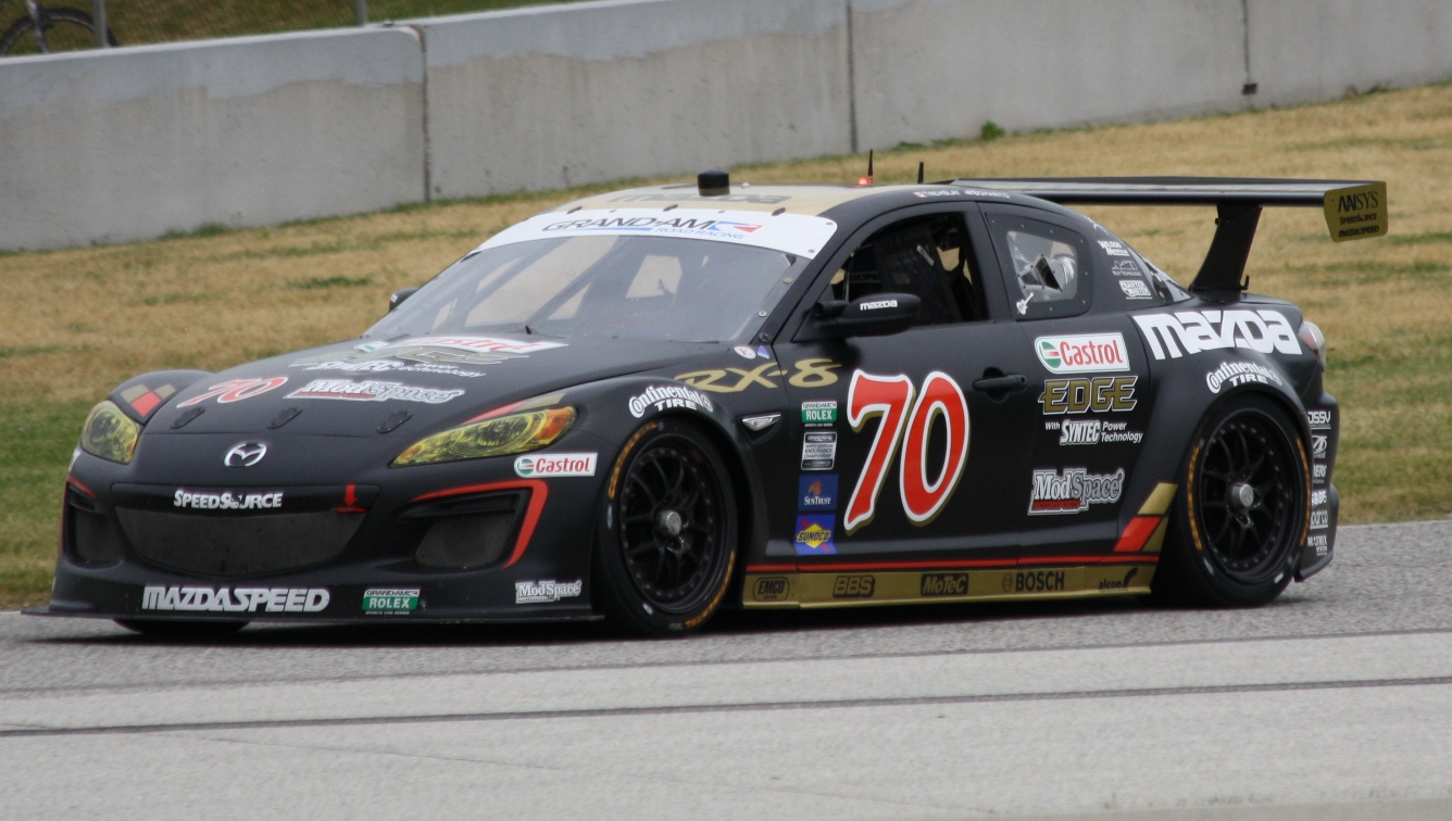 Black SpeedSource Mazda RX-8 GT race car number 70 with a large rear wing and Castrol and Mazdaspeed decals on track