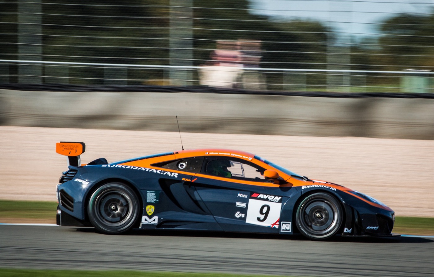Blue and orange McLaren 12C GT3, number 9, at speed through a corner