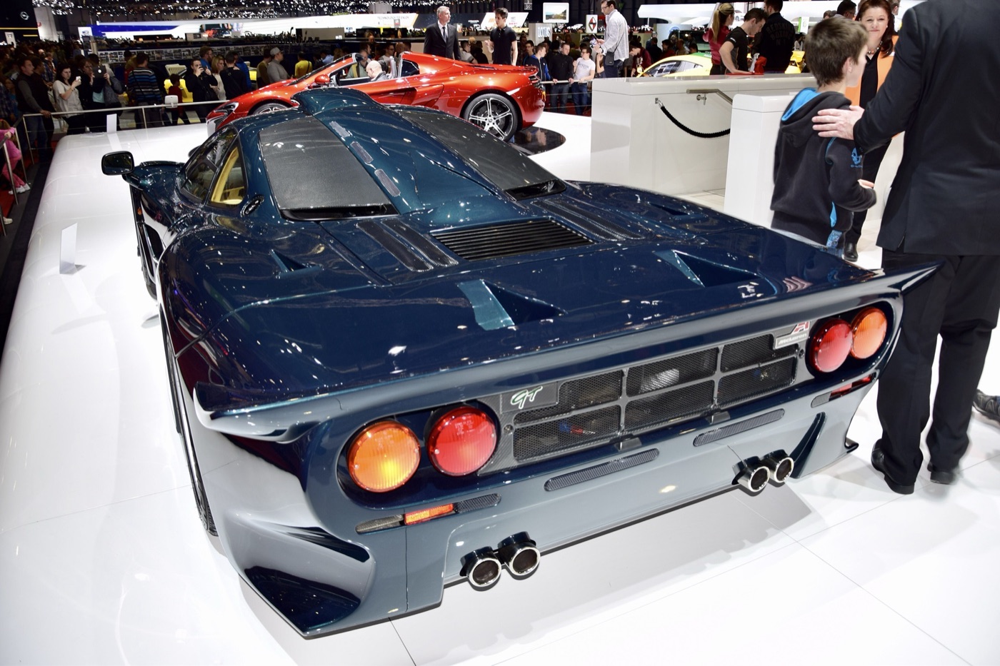 Rear view of a dark blue McLaren F1 GT showing its extended tail and twin exhausts