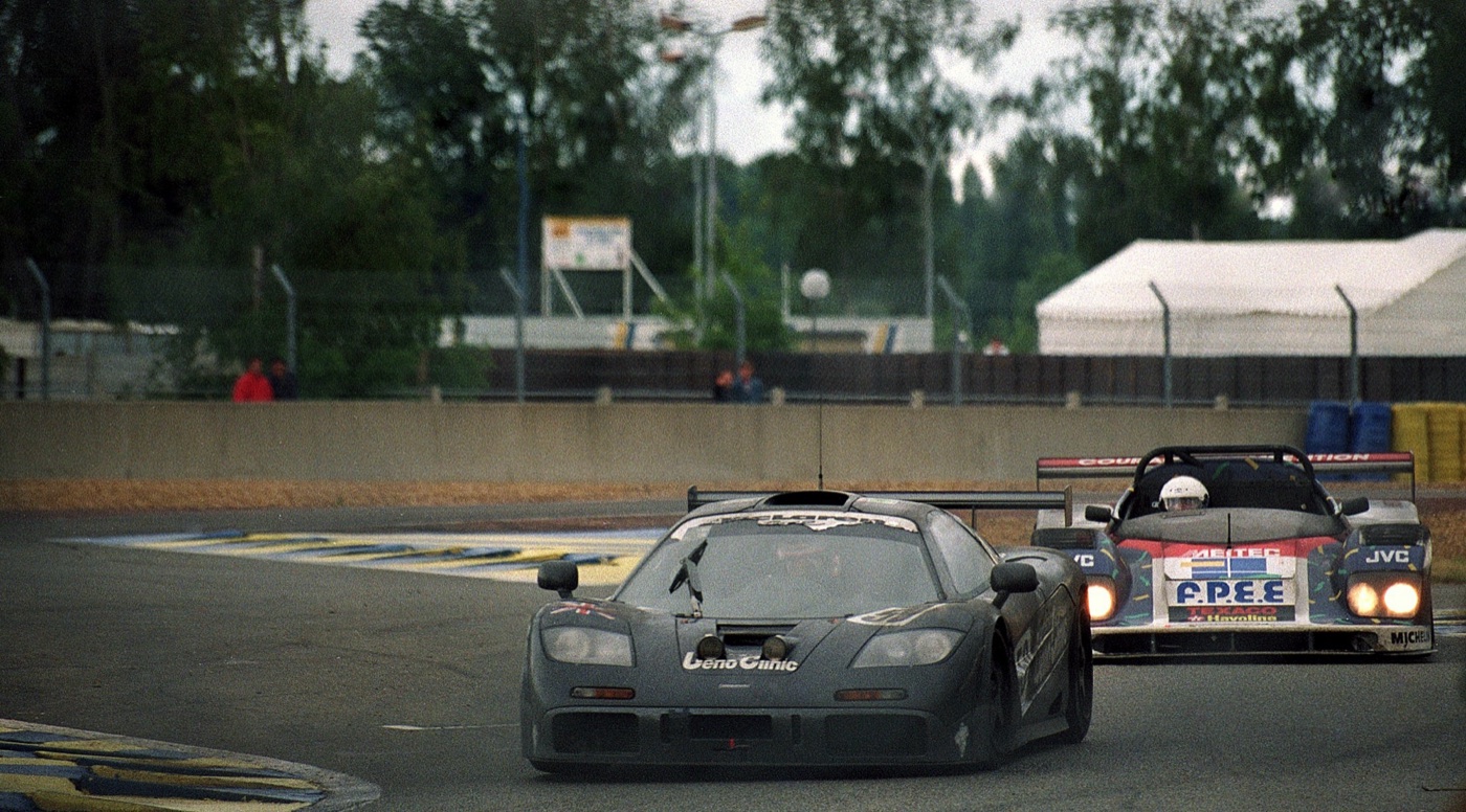 Black McLaren F1 GTR number 59 leading a Courage prototype through the Ford chicane at Le Mans