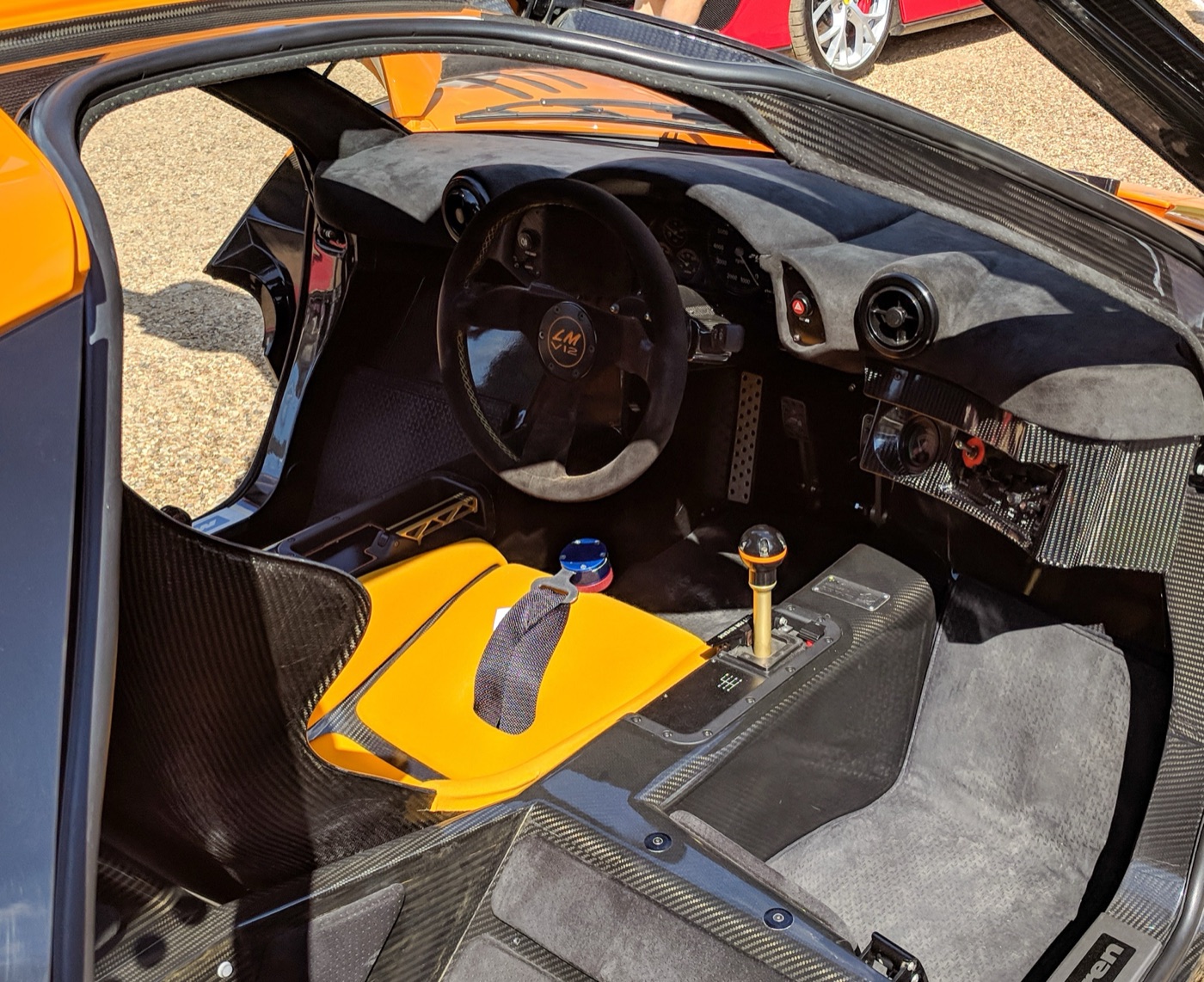 Cabin of a McLaren F1 LM seen through the open door, with the central driver