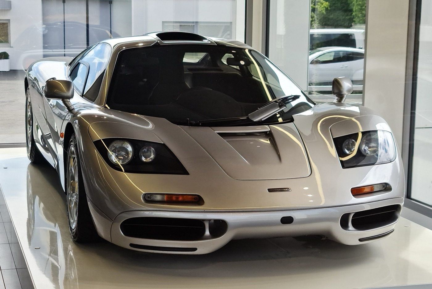 Silver McLaren F1 road car seen from the front, with its roof-mounted engine air intake