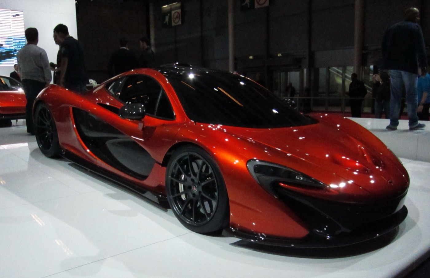 Red McLaren P1 design study on a white turntable at the 2012 Paris Motor Show