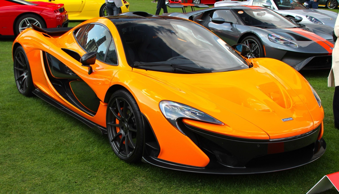 Orange McLaren P1 prototype XP05 parked on grass at the London Concours