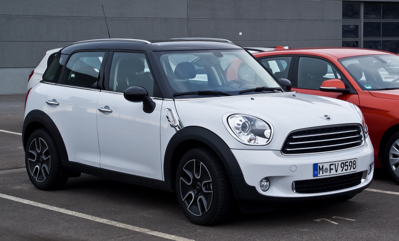 White MINI Cooper D Countryman with a black roof parked in a dealer car park