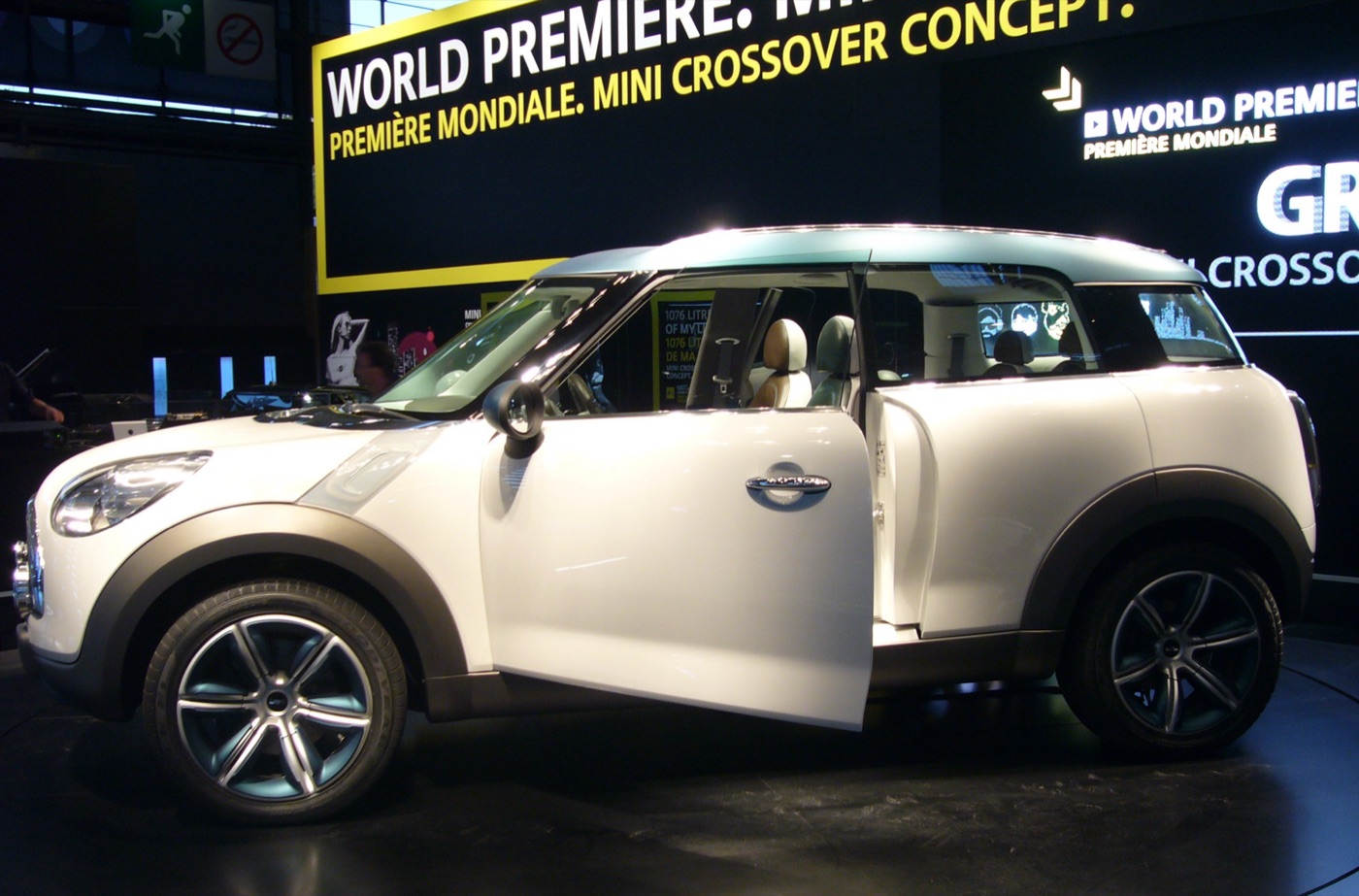 White MINI Crossover Concept with its front door open under a World Premiere sign on a motor show stand