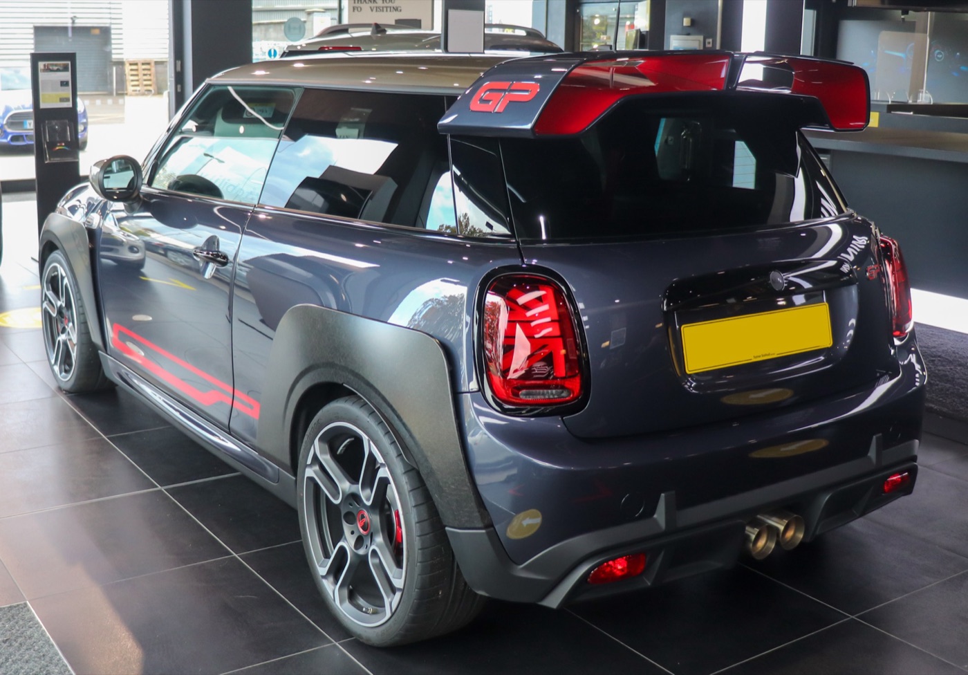 Racing Grey 2020 MINI John Cooper Works GP from the rear with its double-wing roof spoiler, carbon-fibre wheel-arch trims and twin central exhausts