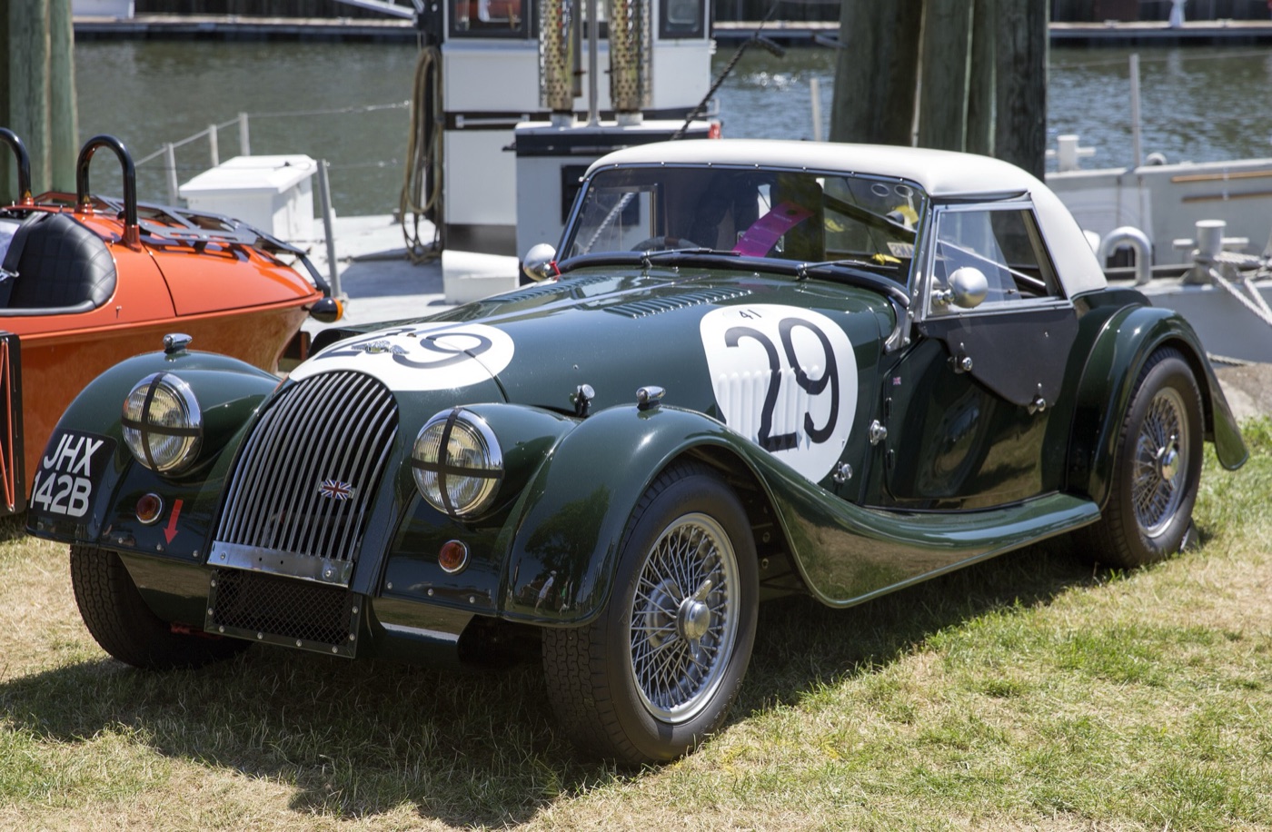 Dark green Morgan Plus Four Super Sports hard top with racing number 29 on its doors and bonnet, parked on grass