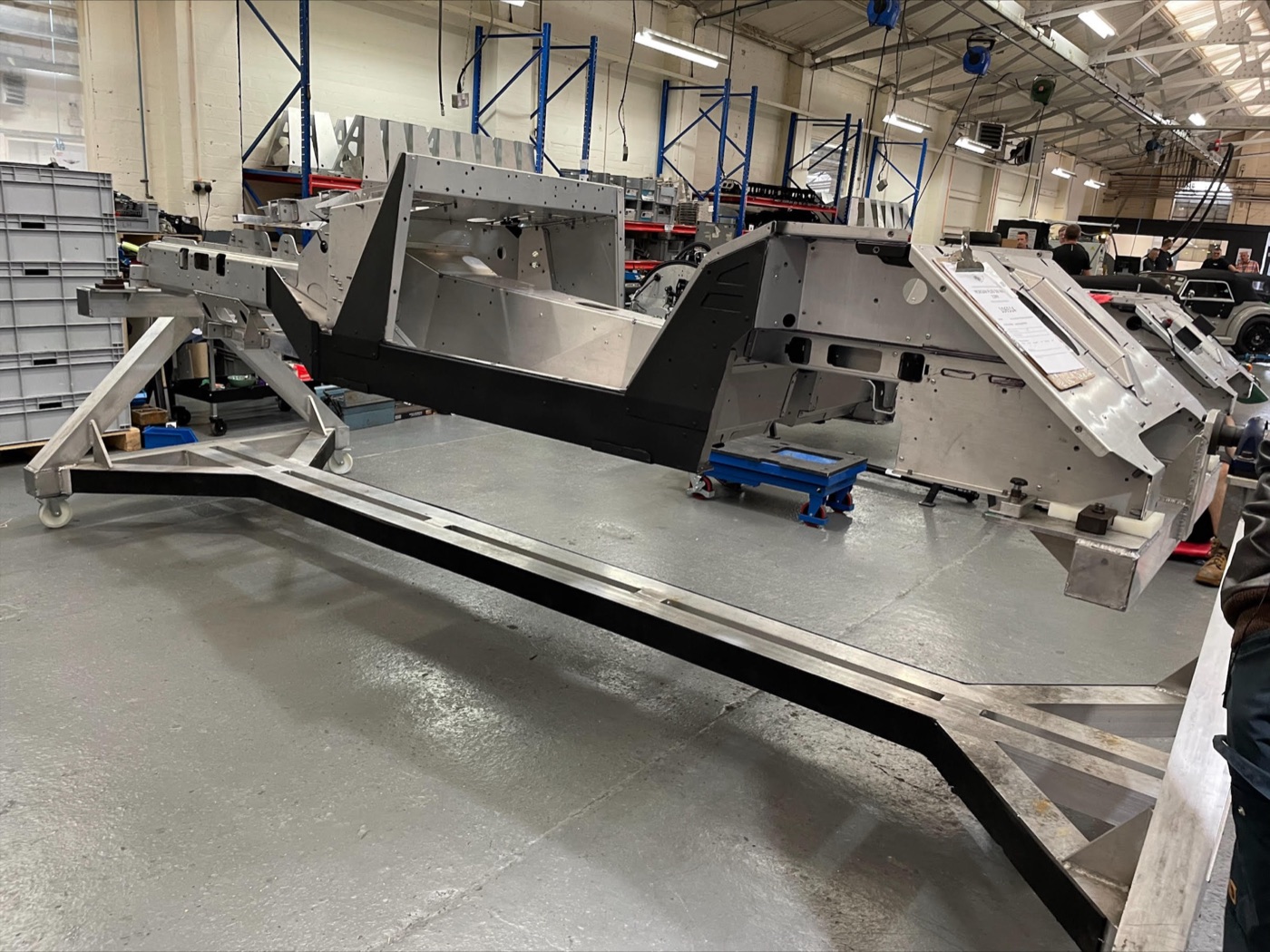 Bare bonded aluminium CX-generation Morgan chassis on a build frame on the factory floor at Malvern