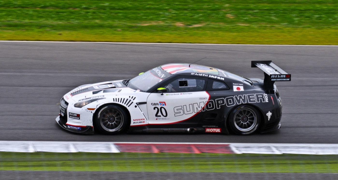 White and black Sumo Power Nissan GT-R GT1 racing car number 20 at speed on the Silverstone circuit