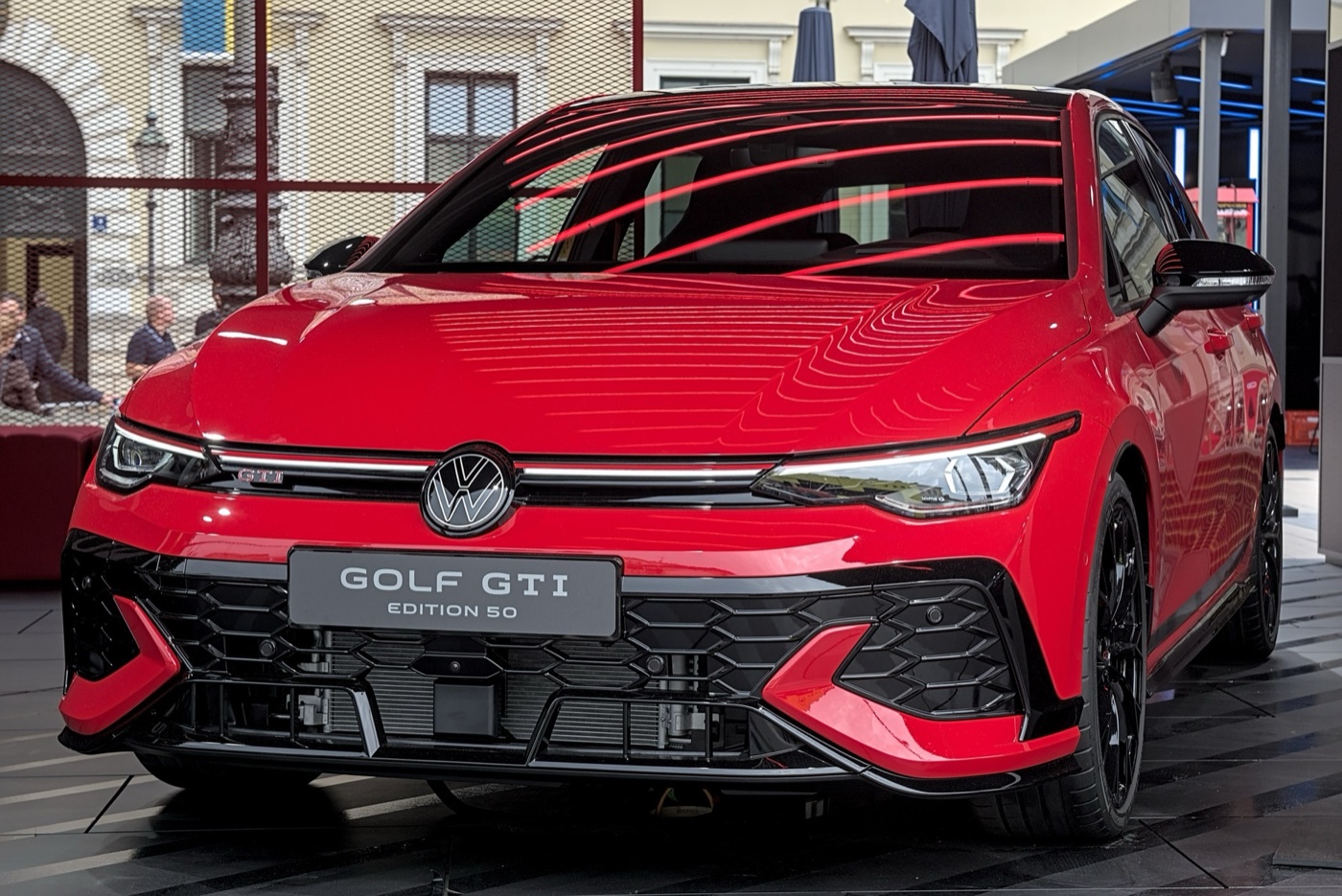 Front of a red Volkswagen Golf GTI Edition 50 with a black lower grille and an Edition 50 plate