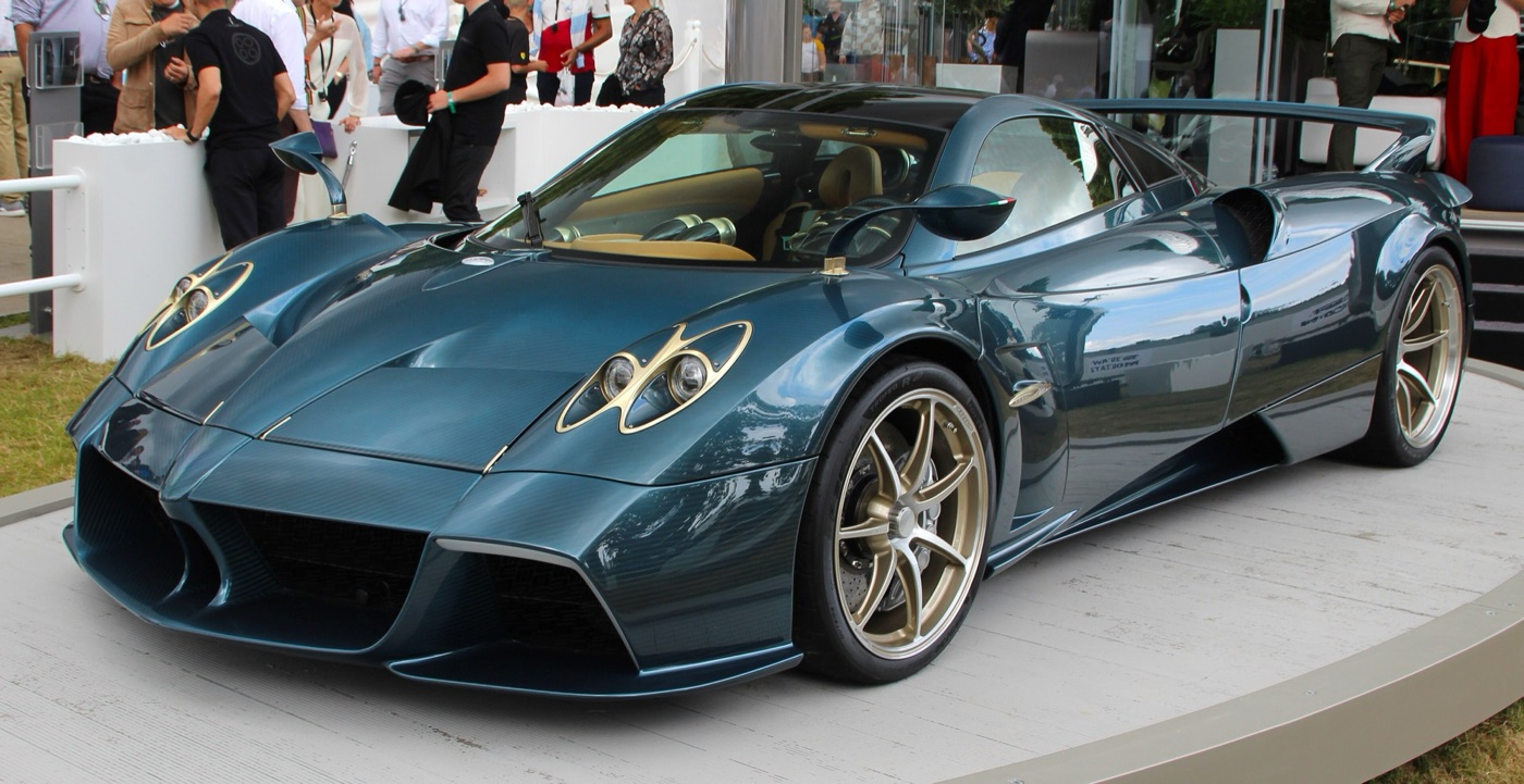 Blue carbon Pagani Huayra Epitome with gold-ringed headlamps and gold wheels on a display plinth