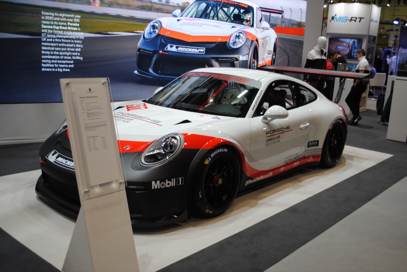 White, red and grey 991.2-generation Porsche 911 GT3 Cup in Carrera Cup Great Britain livery on an exhibition stand