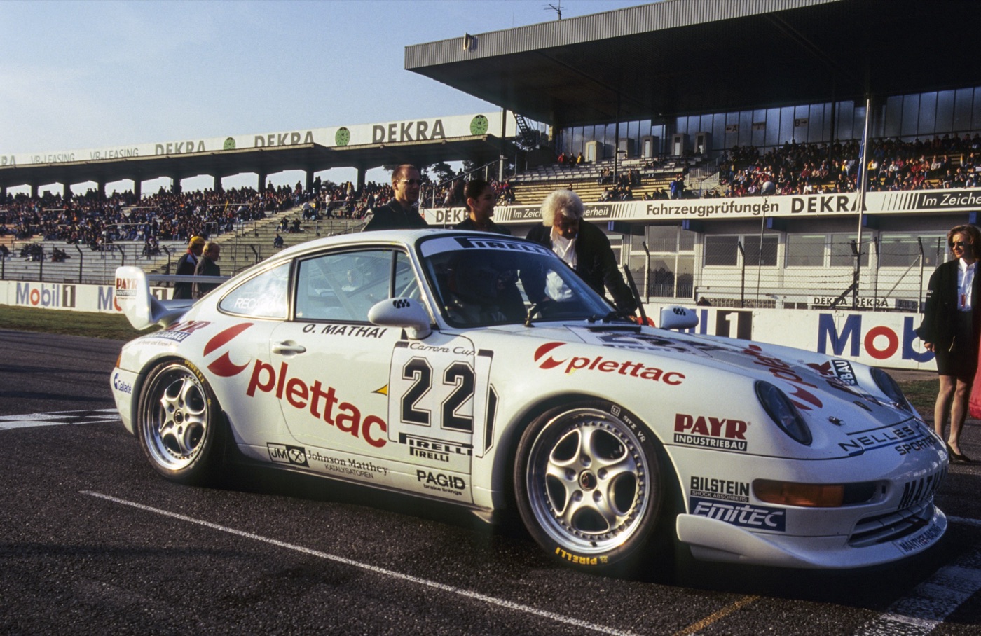 White 993-generation Porsche 911 Cup, number 22, on the grid of a Carrera Cup race in front of the Hockenheim grandstand