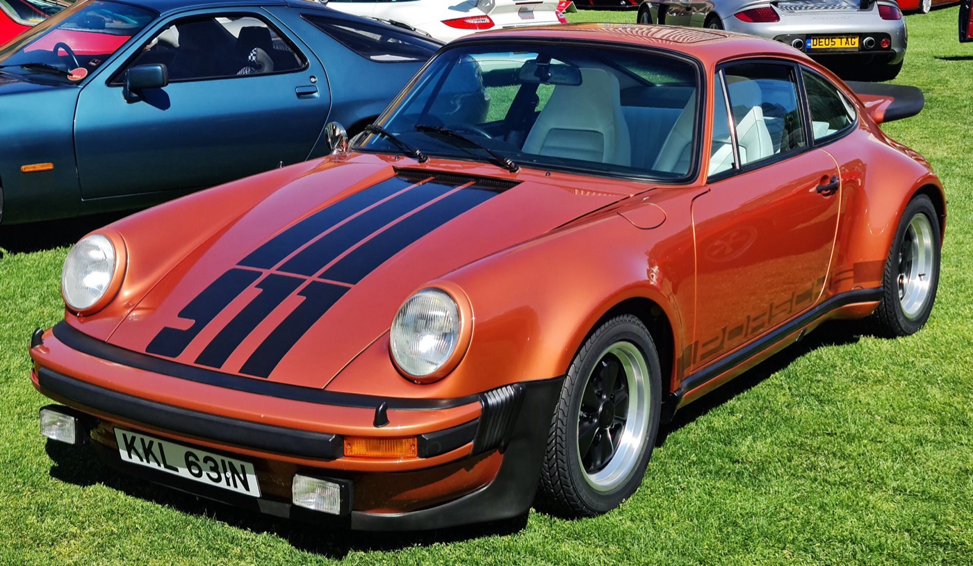 Copper 1975 Porsche 911 Turbo (930) with black bonnet stripes, wide wheel arches and impact bumpers